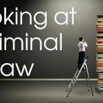 Cover Banner: Looking at Criminal Law: photo of man on ladder examining a huge stack of books