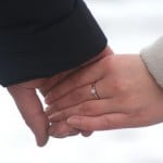 holding hands with engagement ring