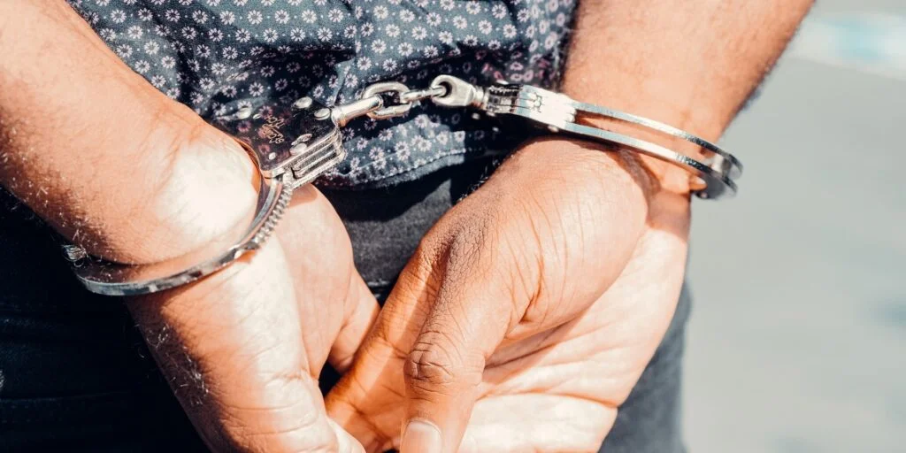 Handcuffs around hands