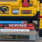 Home improvement themed books sitting under thickness planer tool