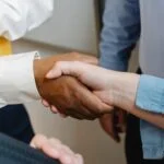 Colleagues shaking hands at work