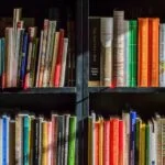 Black bookshelf with coloured books lining the shelves