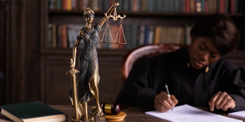 A Figurine of the Lady Justice on the Table of a Judge