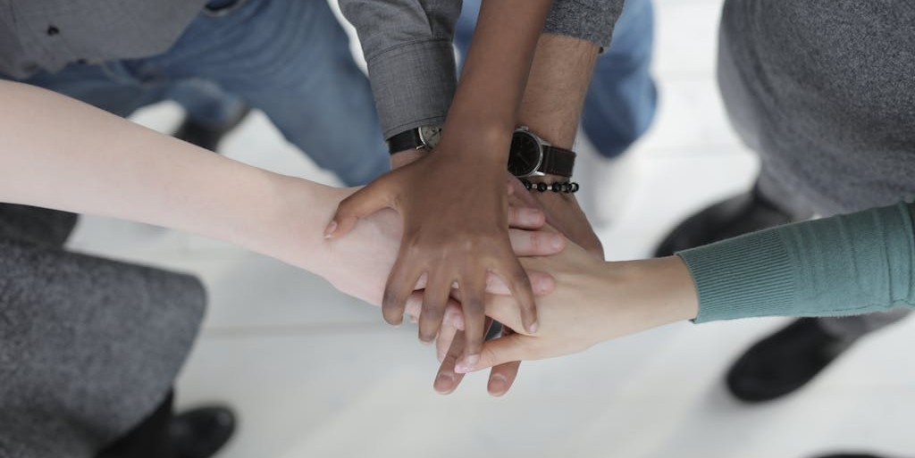 Group of people stacking hands