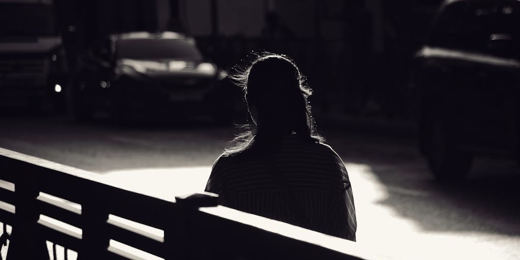 Silhouette of a Person on a City Street in Shadow